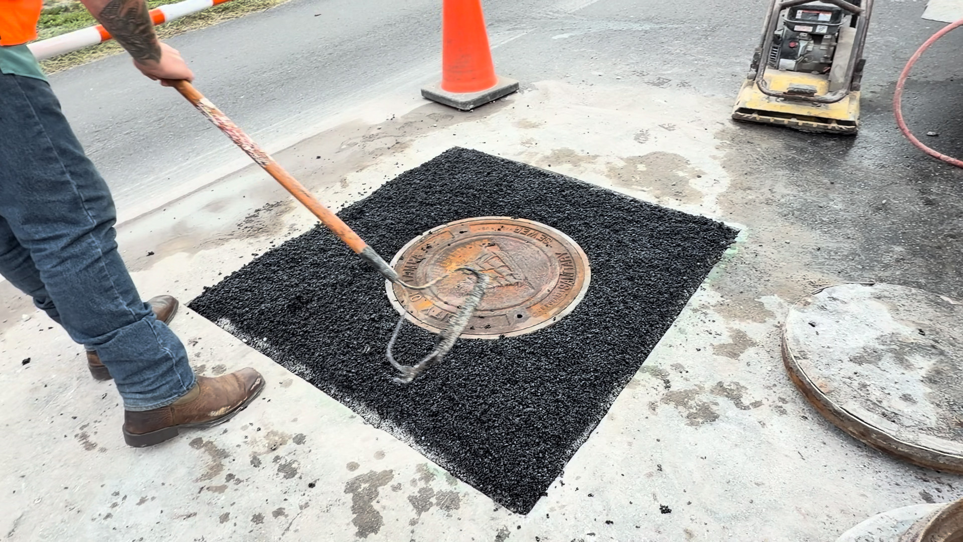 Crew raking the Aqua level with the surrounding pavement before compaction