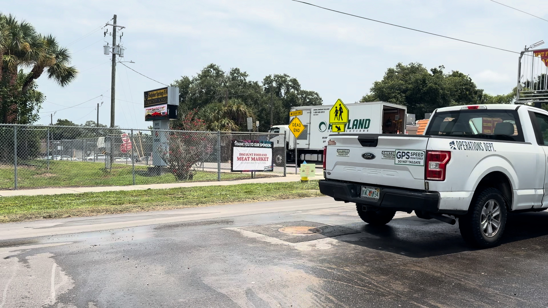 Traffic passing over the finished Perma-Patch Aqua manhole collar the same day it was placed, north Tampa