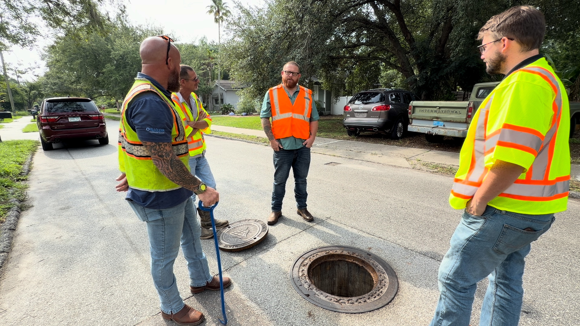 Rowland crew talking through the inspection around an open City of Tampa manhole